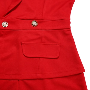 Detailed macro view of red suit jacket waist featuring gold lion head embossed buttons