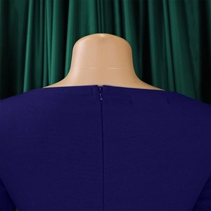 Detail view of high-quality invisible back zipper on textured dark purple elegant dress