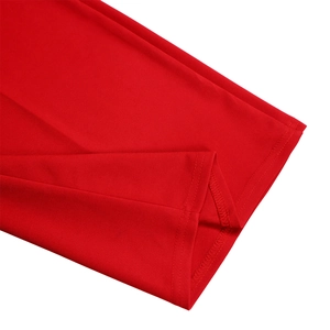 Detailed close-up of double-needle stitching on red wide-leg jumpsuit fabric hem