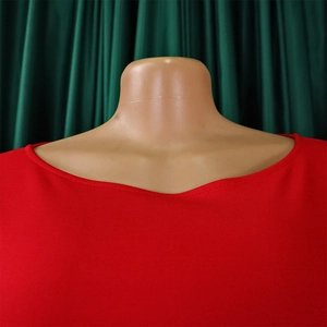 Close-up of red solid color dress fabric showing fine knit texture and neckline detail