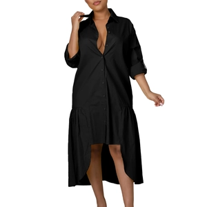 Detail of high-low asymmetrical hem with ruffled trim on black long sleeve shirt dress