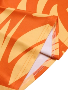 Close-up of vibrant orange abstract print fabric with precise double stitching details