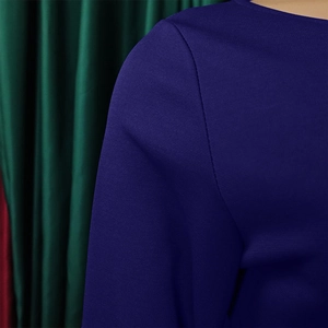 Detail of navy blue knit fabric showing refined texture on the shoulder and sleeve cuff