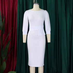 Detail of white pencil dress featuring puff sleeves and elegant waist ruffle accents