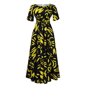 Detail of African print maxi dress with yellow patterns and waist tie on black fabric