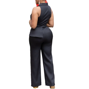Back view of a black two-piece set featuring a peplum top and straight-leg trousers