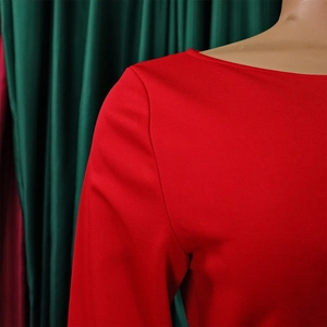 Detail of red boat-neck maxi dress showing smooth fabric texture and shoulder line