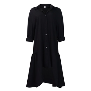 Detail of black shirt dress with white buttons and irregular pleated hemline design