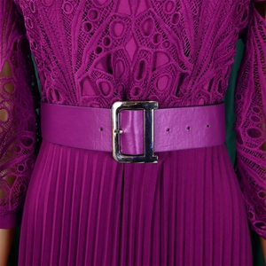 Detail of purple waist belt featuring a polished silver metal D-shaped buckle on lace dress
