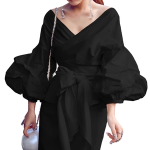 Detail of black V-neck puff sleeve blouse with adjustable waist tie and bow detail