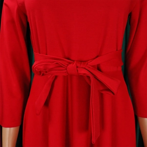 Close-up of bright red dress waist featuring a stylish tied bow and premium fabric texture