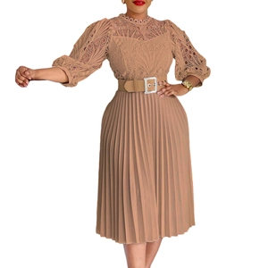Close-up of khaki dress featuring hollow lace bodice, lantern sleeves and pleated skirt