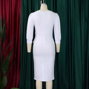 Detail of white pencil dress featuring 3/4 puff sleeves and a sleek back zipper closure