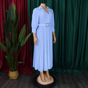 Detail of elegant V-neck pleated dress featuring a matching belt with a gold buckle