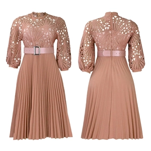 Detail of elegant lace hollow-out sleeves and pleated skirt on a dusty pink dress
