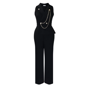 Detail of elegant black jumpsuit featuring a lapel collar and golden chain waist belt