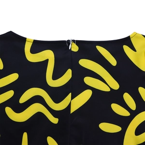 Detail shot of invisible zipper and vibrant yellow abstract print on back neckline