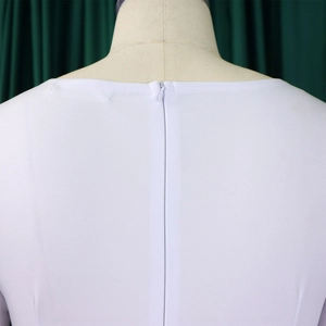 Close-up of invisible zipper and textured fabric on the back of the white dress