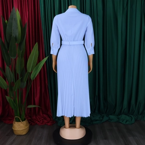 Close-up detail of light blue pleated maxi dress showing waist tie and fine pleats