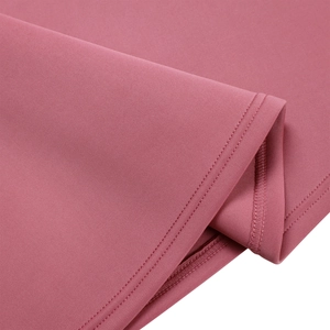 Detail view of double-needle stitching and fine knit texture on a dusty pink evening dress