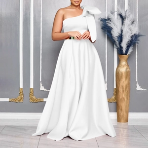 Detail of elegant white one-shoulder gown with large bow and gold belt for formal events