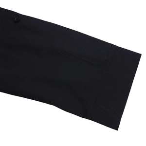 Detailed close-up of a black long sleeve dress featuring premium fabric and button detail