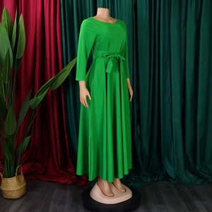 Detail of waist tie and belt on a bright green long sleeve A-line maxi dress