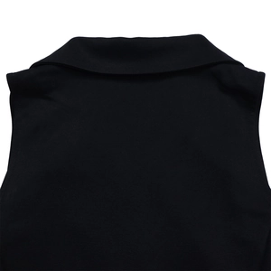 Detailed close-up of a black notched lapel collar on a stylish breathable knit jumpsuit