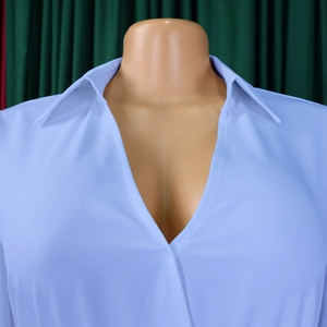 Detail shot of elegant light blue V-neck pleated dress with smooth chiffon fabric texture