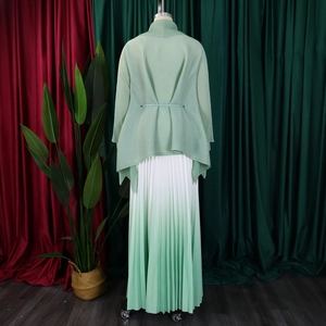 Dettaglio della chiusura con lacci sul retro e della trama plissettata dell'elegante set verde