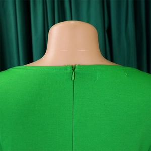 Detail of water-drop invisible zipper on the back of the bright green maxi dress