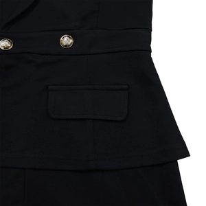 Detailed macro of the black blazer fabric with decorative gold embossed buttons