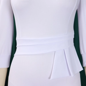 Detail of white slim-fit dress featuring layered peplum waist and wrap-around belt design