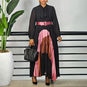 Detail of color-block pleated skirt and waist belt on a black elegant dress