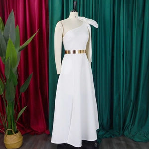 Detail of white one-shoulder evening gown featuring a large bow and metallic gold waist belt