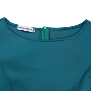 Detail view of the teal evening dress neckline with a discreet back zipper and brand label
