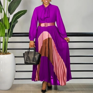 Detail of elegant pleated purple dress with geometric color block design and ribbon tie neck