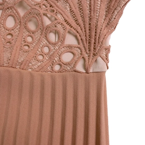 Detailed view of the lace hollow embroidery and pleated fabric on the dusty pink dress