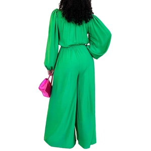 Back view of bright green long sleeve jumpsuit with wide legs and cinched waist