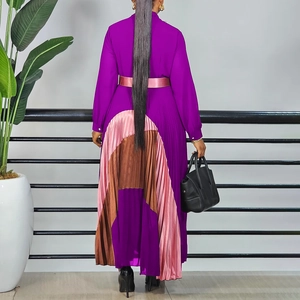 Detail view of the pleated hem and pink satin ribbon belt on this elegant purple dress