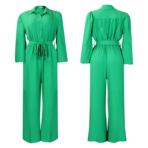 Front and back detail of a vibrant green long-sleeve jumpsuit with a tie-waist belt