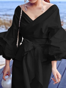 Elegant black off-shoulder wrap top with dramatic puff sleeves and large waist bow tie