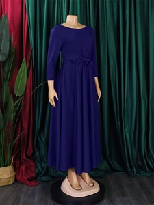 Elegant navy blue long sleeve A-line maxi dress with waist tie on a mannequin