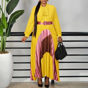 Detail of pleated maxi dress with mustard yellow fabric and colorful fan-shaped inserts