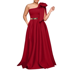 Detail of red one-shoulder evening gown featuring a large bow and metallic gold belt