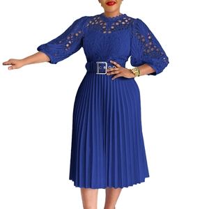 Detail of royal blue lace dress featuring intricate floral hollow out and pleated skirt