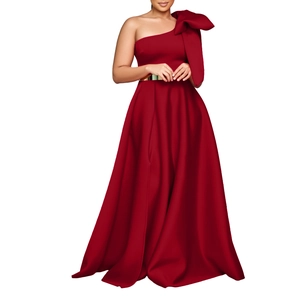 Detail of the elegant burgundy satin evening gown featuring a large shoulder bow and gold belt