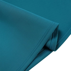 Detail of premium stitching and seam finish on a dark teal evening dress fabric