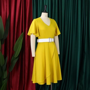 Detail of yellow V-neck dress with ruffle sleeves, white belt, and asymmetric hemline