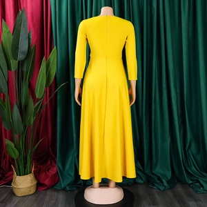 Detail view of yellow long sleeve maxi dress back with invisible zipper and A-line hem